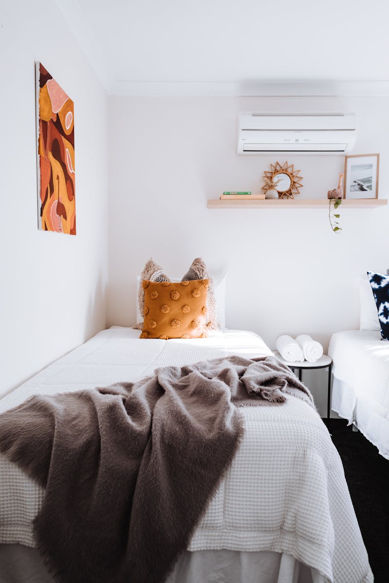 Photo by Rachel Claire Light bedroom with cushions on bed